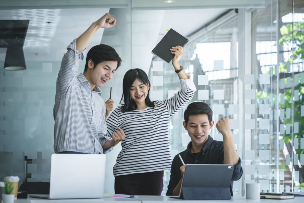 Happy employees celebrating success in a supportive future-ready workforce environment.