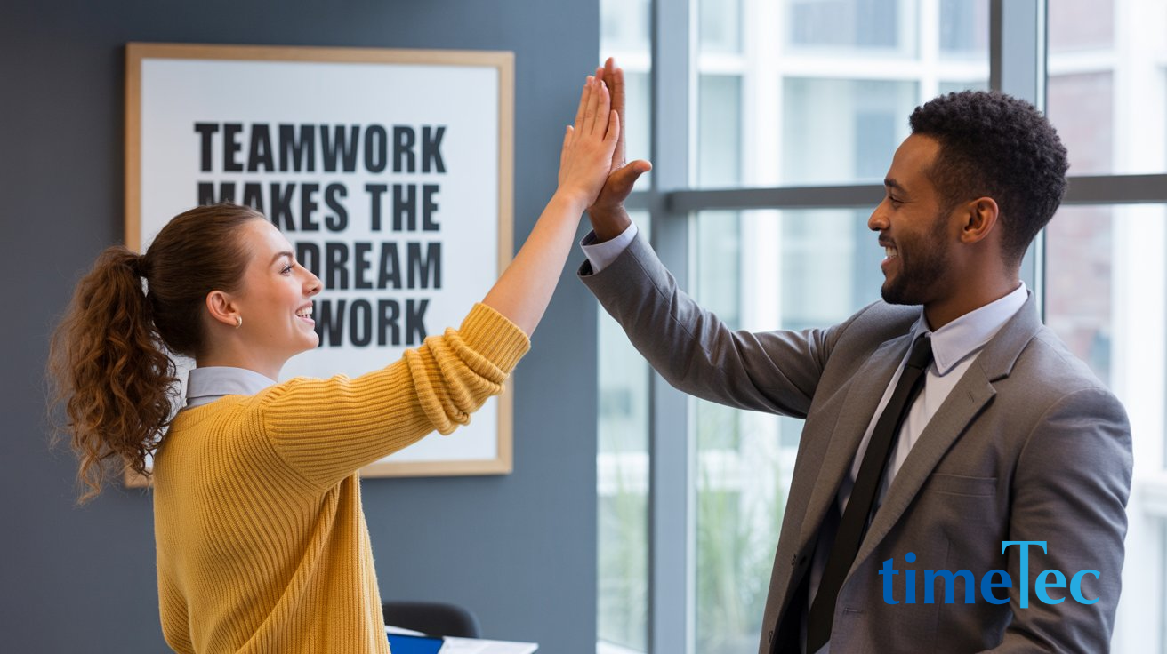 Two professionals celebrating teamwork in the office — a symbol of HR in preventing workplace burnout.