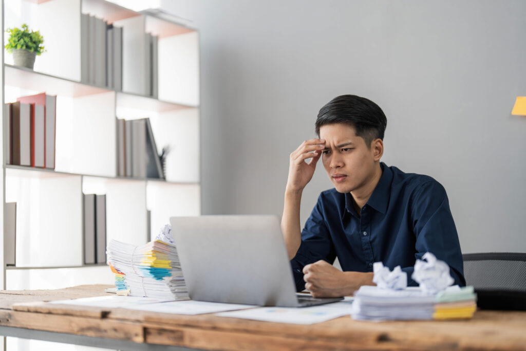 Stressed employee struggling with workload, highlighting the need for talent retention strategies