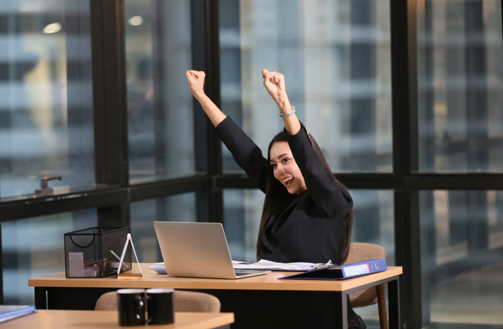 Happy employee celebrating success due to effective talent retention strategies