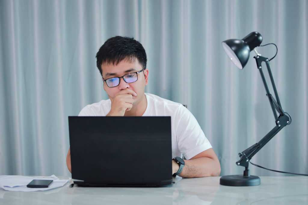 Focused employee evaluating employer branding strategy on a laptop
