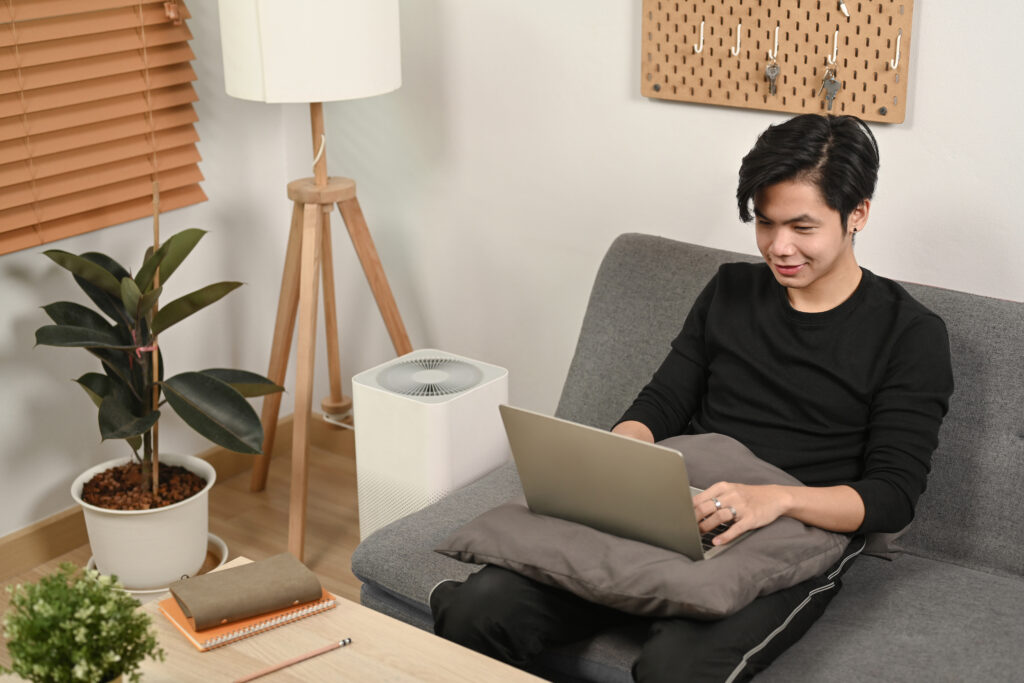 Remote employee accessing HR tools from home using HRMS in crisis management setup.