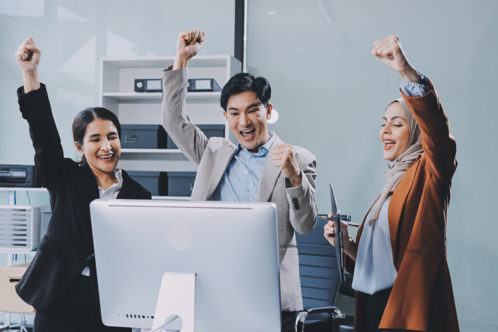 Diverse team celebrating success, reflecting strong company culture and employer branding