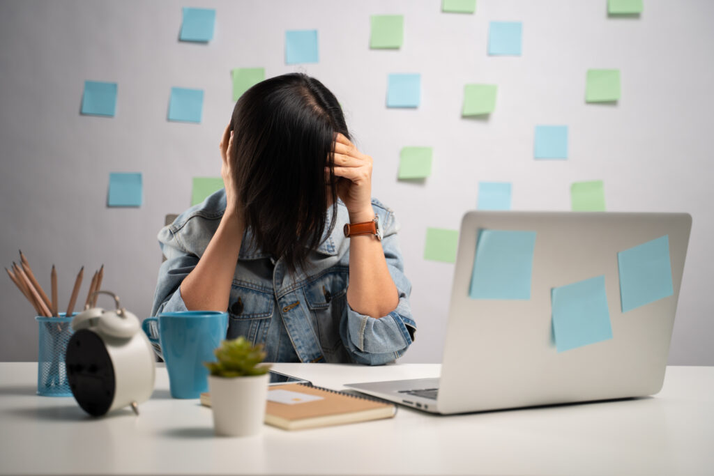 Employee stressed at work showing the impact of leave management on employee satisfaction