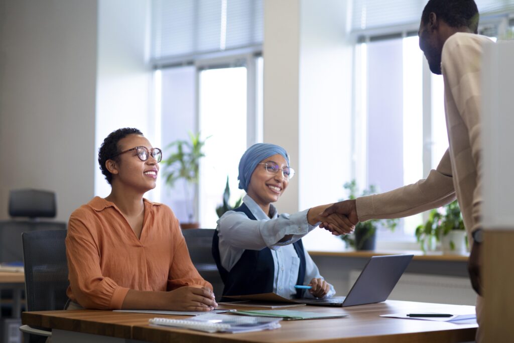 Employer shaking hands with a newly hired employee.