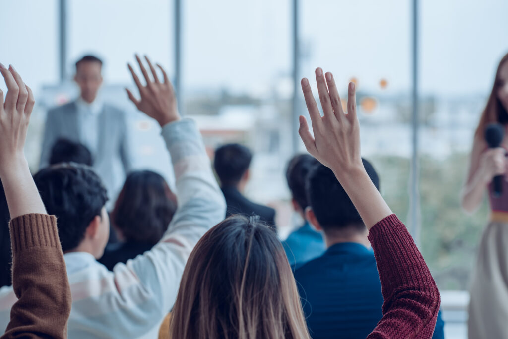 Owners raising hands to vote during a Joint Management Body Malaysia AGM meeting