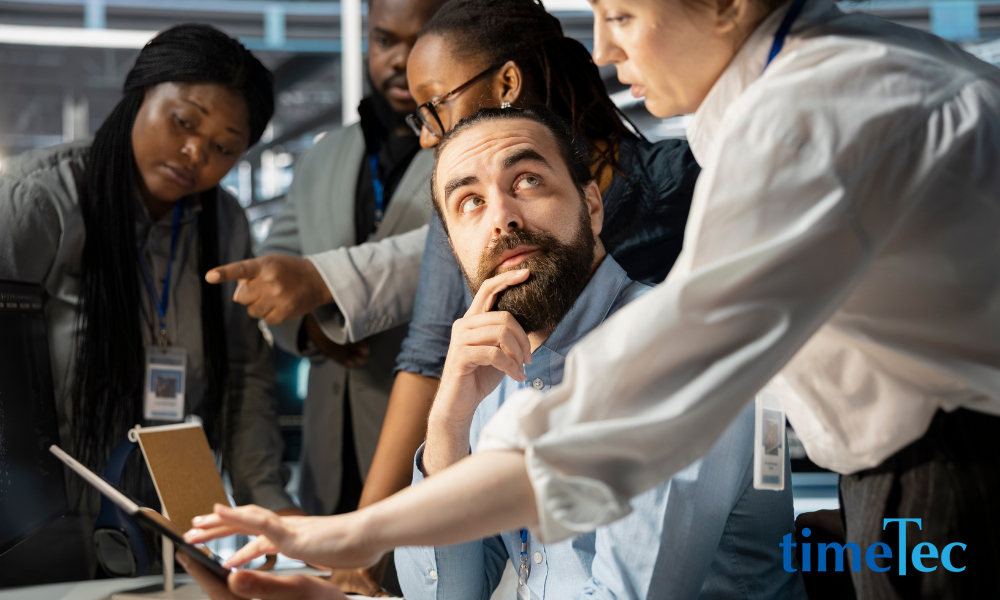 HR manager explaining EA Form requirements to employees during Malaysia’s tax season.