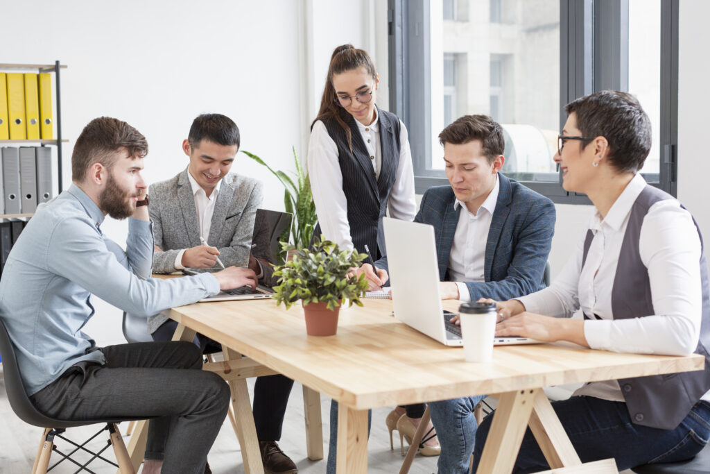 HR professionals discussing parental leave policies in a modern Malaysian office.