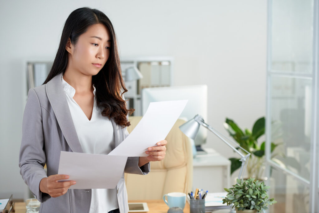 Female employee reviewing documents before her final working day