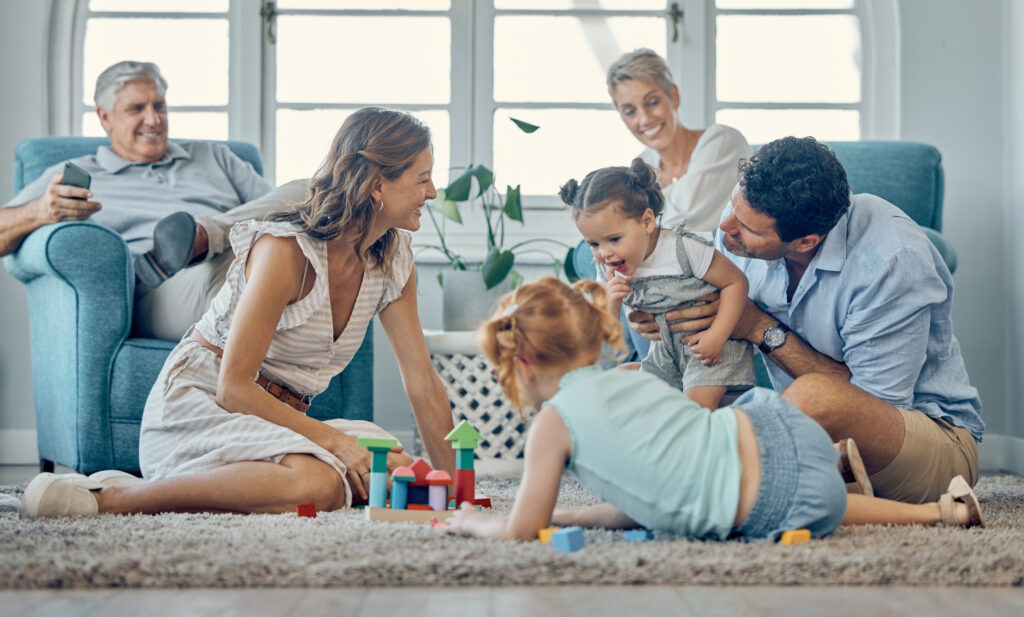 Grandparents, parents and children spending time together in a living room