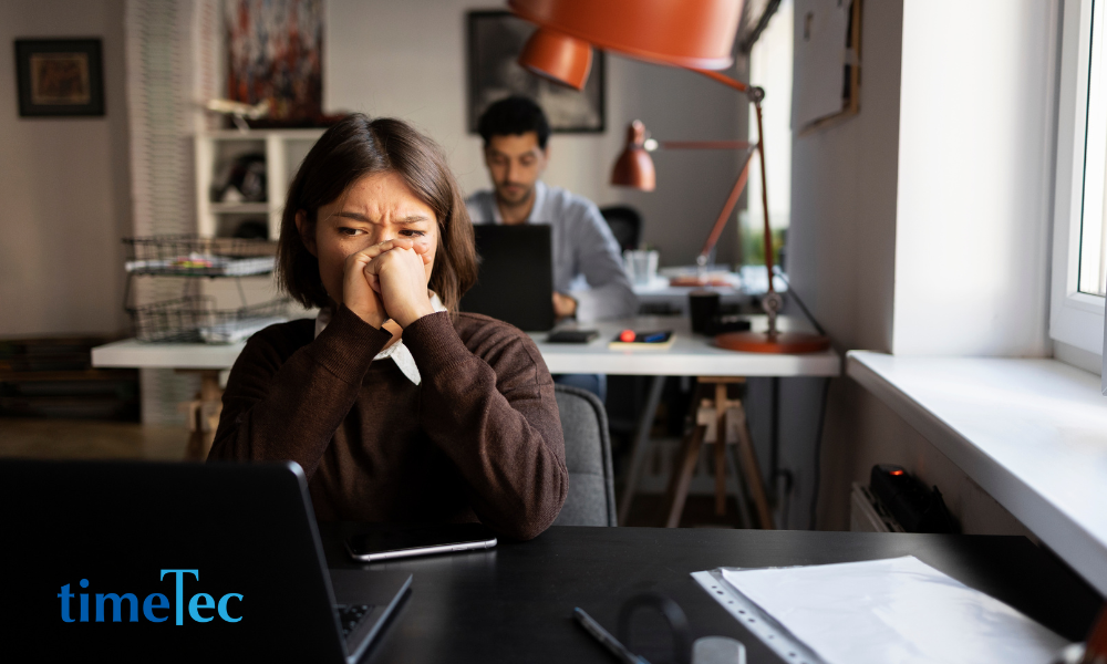 Worried employee at her desk after receiving difficult personal news