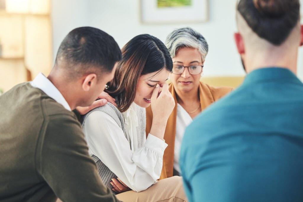 Colleagues comforting a coworker during a difficult moment at work