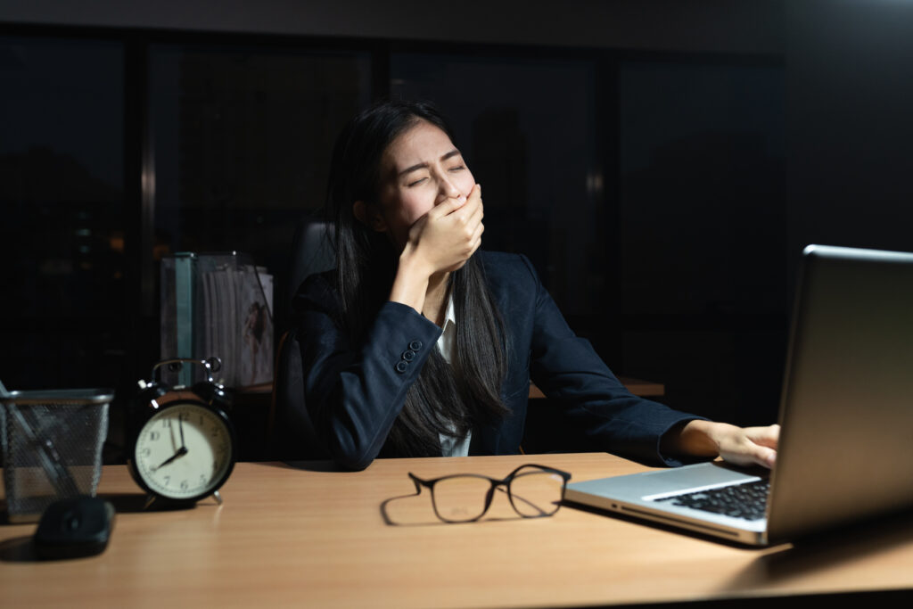 Employee working overtime at a desk late in the evening