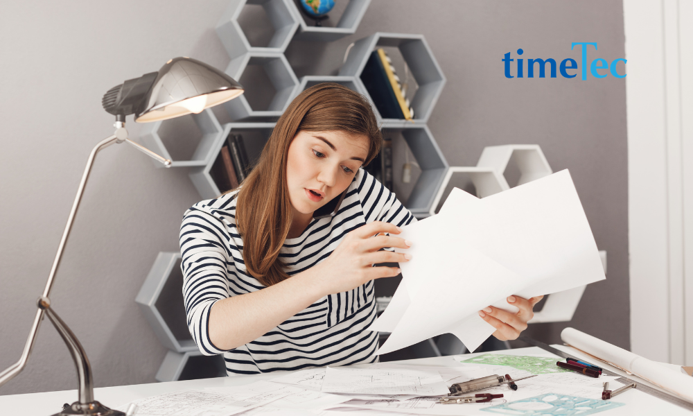 Professional reviewing paperwork and documents at a desk