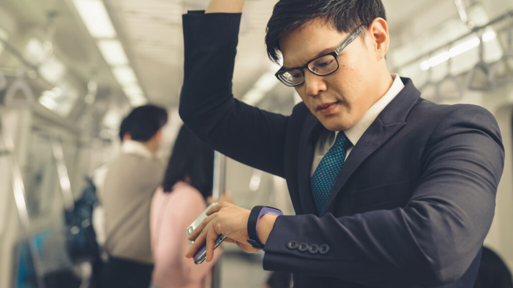 Employee checking his watch after arriving late to work