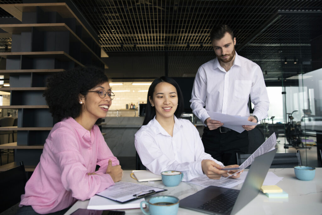 HR and finance team reviewing documents together in an office setting