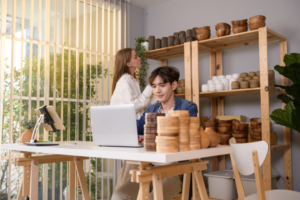 Small business employees reviewing documents at a workspace with products on display