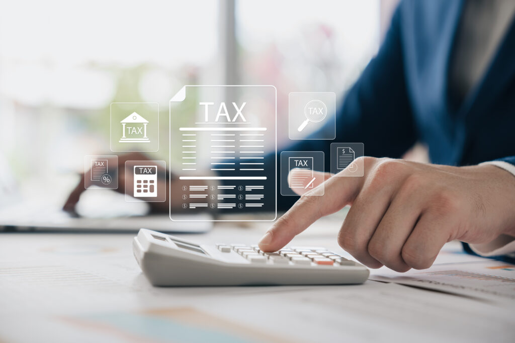 Hand using calculator with digital tax interface on screen